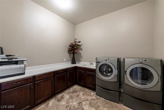 washroom with sink and washer and dryer