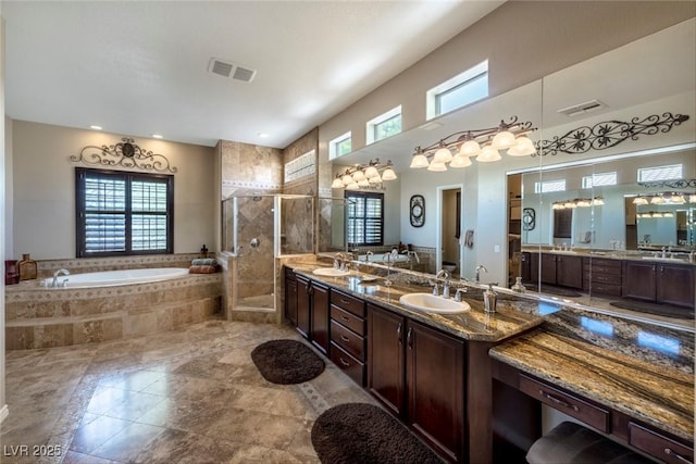 bathroom featuring vanity and independent shower and bath