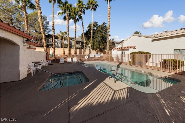 view of pool with a community hot tub and a patio