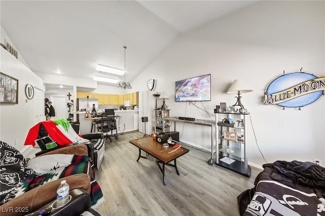 living room with light hardwood / wood-style flooring and lofted ceiling