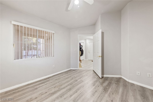 spare room featuring light hardwood / wood-style floors and ceiling fan