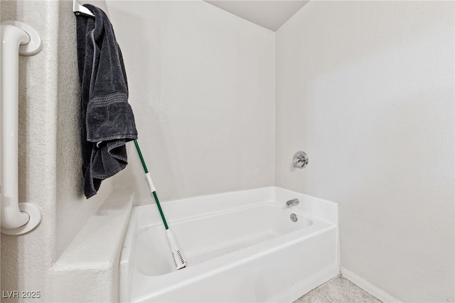 bathroom featuring tile patterned floors and a bathtub