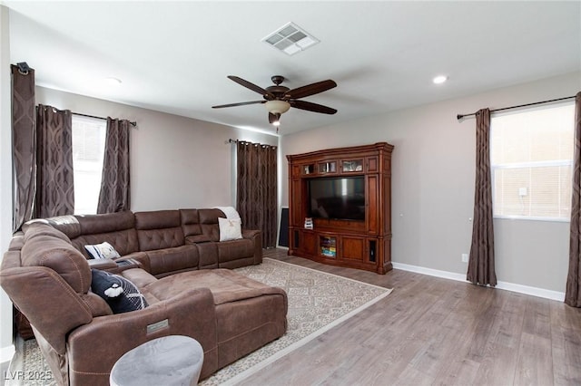 living room with ceiling fan and light wood-type flooring