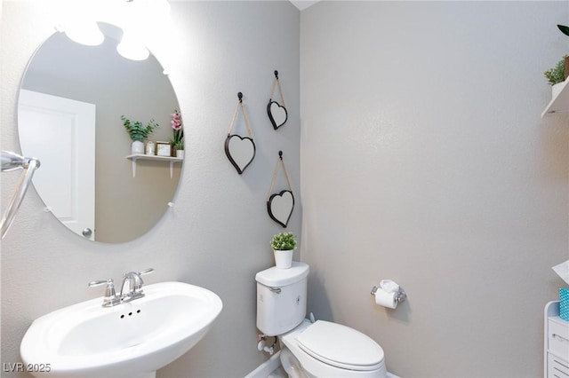 bathroom with toilet and sink