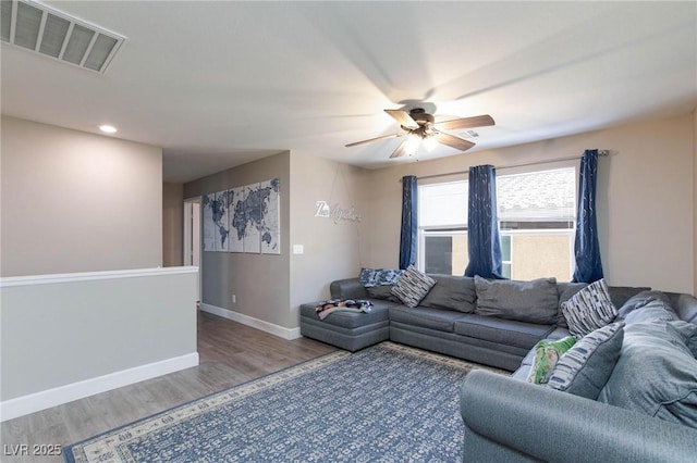 living room with hardwood / wood-style flooring and ceiling fan