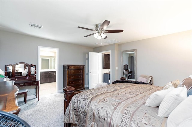 carpeted bedroom featuring ceiling fan and ensuite bath