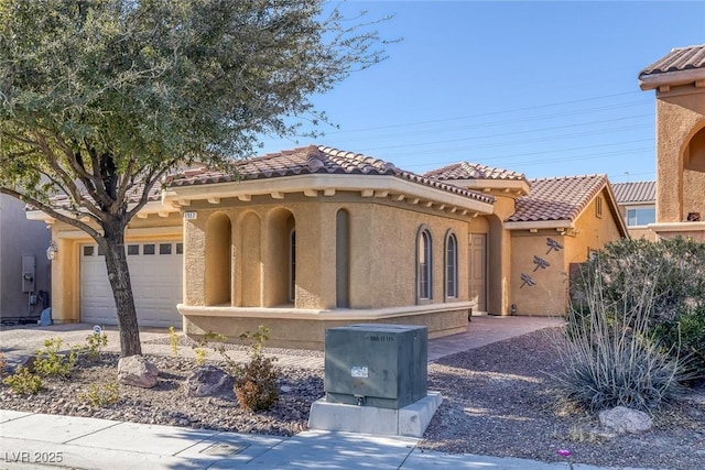 mediterranean / spanish-style home with a garage