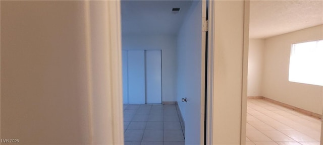 hallway featuring light tile patterned floors