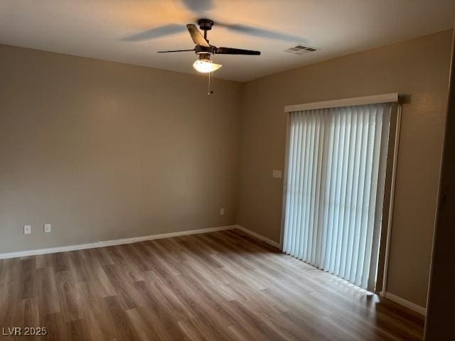 empty room featuring light hardwood / wood-style flooring and ceiling fan