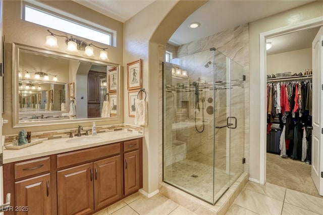 bathroom featuring tile patterned floors, vanity, and an enclosed shower