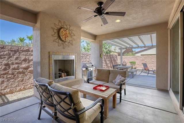 view of patio / terrace with an outdoor living space with a fireplace, grilling area, and ceiling fan