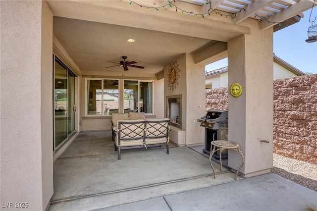 view of patio / terrace featuring an outdoor living space with a fireplace, ceiling fan, and a grill