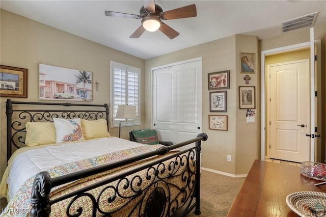 bedroom with light colored carpet, a closet, and ceiling fan