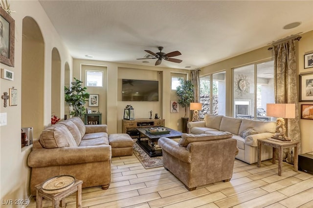 living room with ceiling fan and plenty of natural light