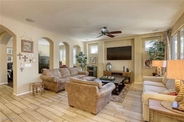 living room featuring ceiling fan and light hardwood / wood-style flooring