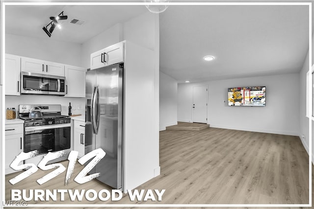 kitchen featuring white cabinets, appliances with stainless steel finishes, and light hardwood / wood-style flooring