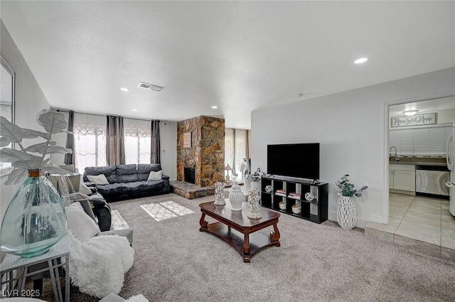 carpeted living room featuring sink