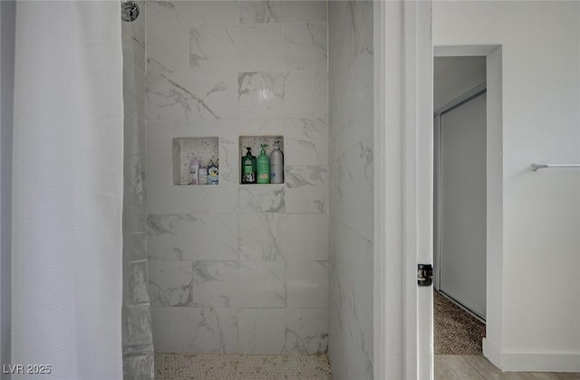 bathroom with tiled shower