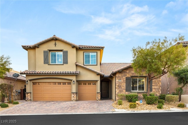 mediterranean / spanish-style house with a garage