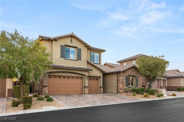 mediterranean / spanish-style house with a garage