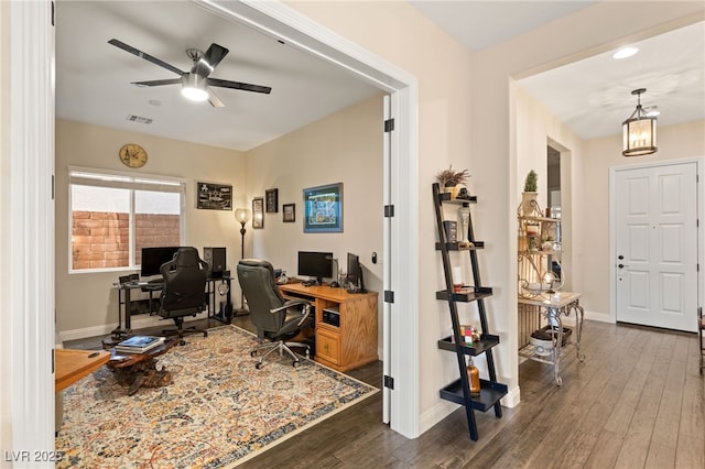 home office featuring dark wood-type flooring and ceiling fan