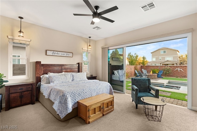 carpeted bedroom featuring multiple windows, access to exterior, and ceiling fan