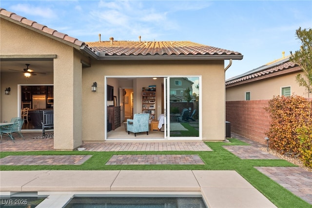 back of property with a patio