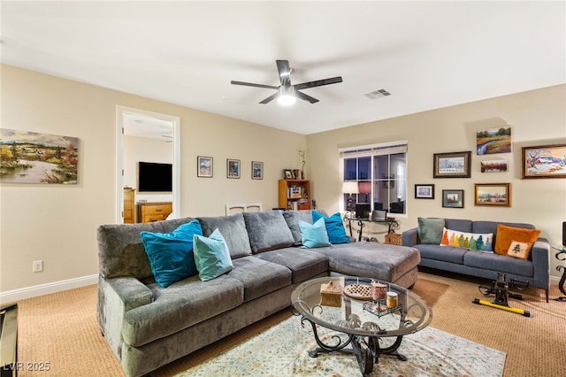 carpeted living room with ceiling fan