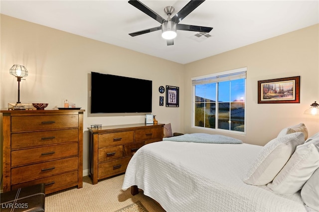 bedroom with ceiling fan and light colored carpet