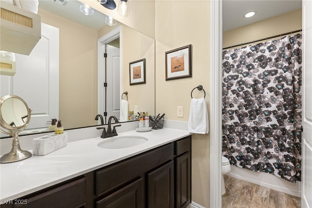 bathroom featuring a shower with curtain, vanity, toilet, and hardwood / wood-style floors