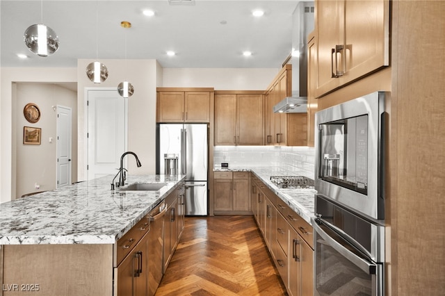 kitchen featuring appliances with stainless steel finishes, dark parquet flooring, backsplash, a center island with sink, and hanging light fixtures