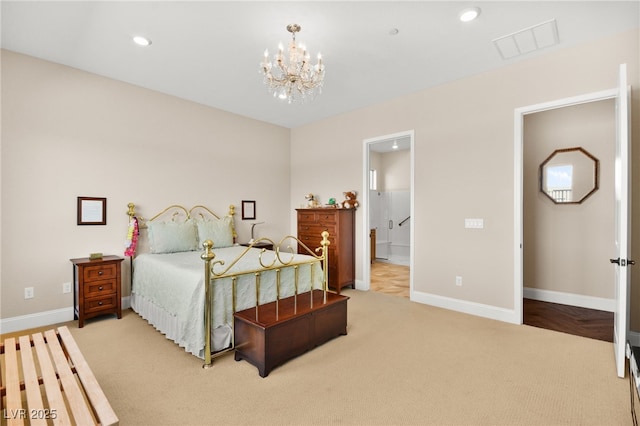 carpeted bedroom featuring an inviting chandelier