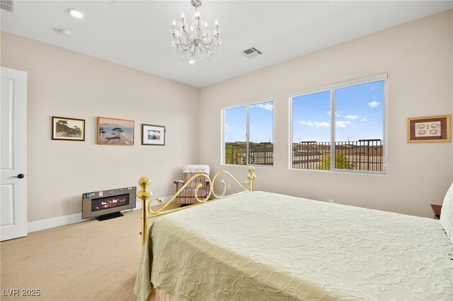 bedroom with carpet and a chandelier