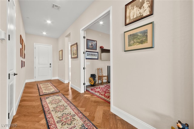 corridor with light parquet floors