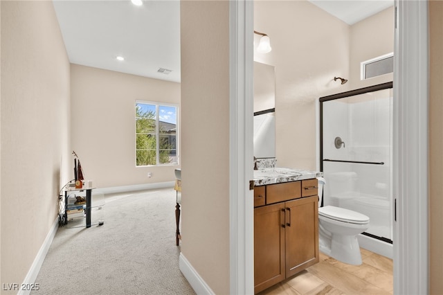 bathroom with vanity, toilet, and a shower with shower door