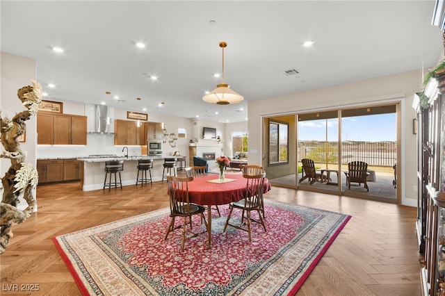 dining area with light parquet floors and sink