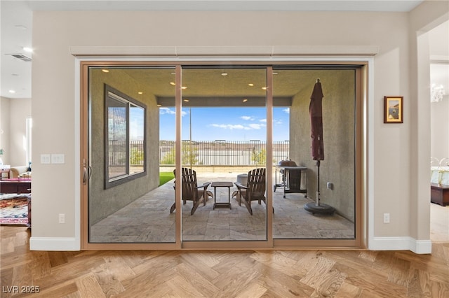 doorway to outside featuring parquet floors