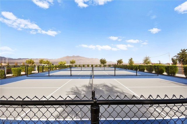 view of sport court featuring a mountain view and basketball court