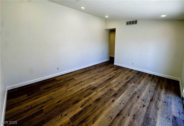 unfurnished room with dark hardwood / wood-style floors and vaulted ceiling