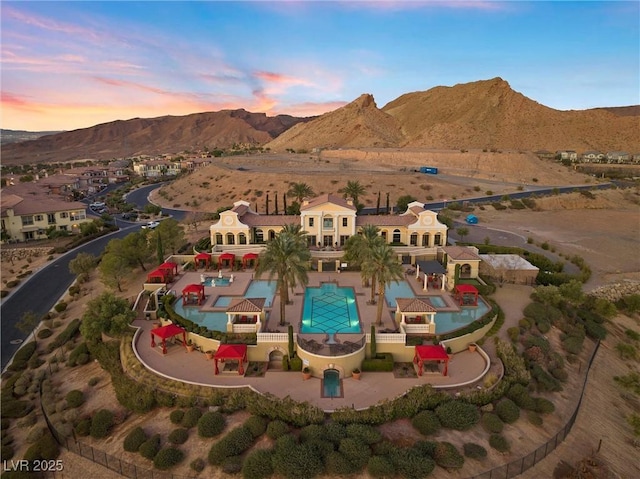 aerial view at dusk featuring a mountain view