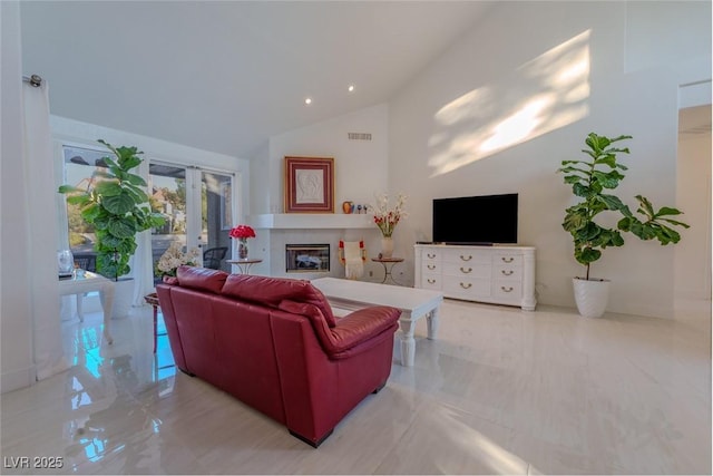 living room featuring vaulted ceiling and french doors