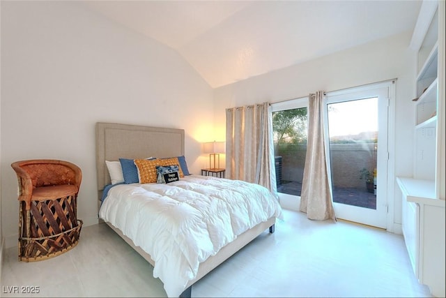 bedroom with lofted ceiling and access to exterior