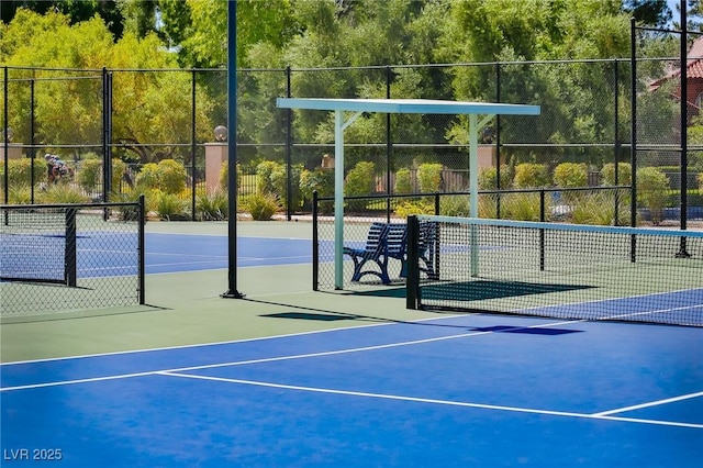 view of tennis court with basketball hoop