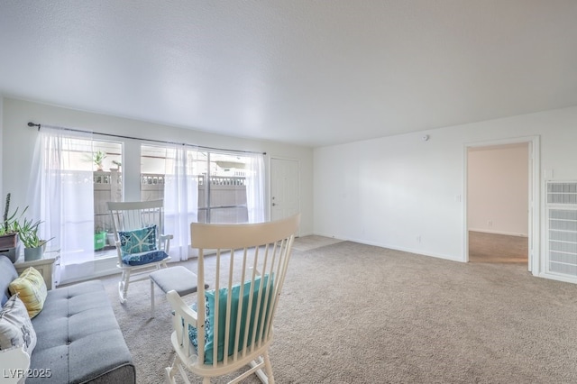 living room featuring carpet floors and a textured ceiling