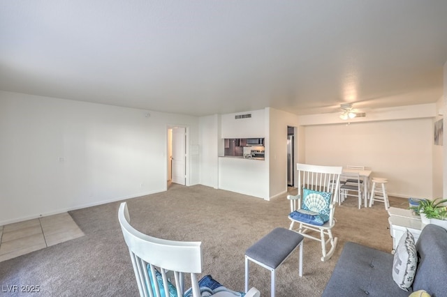 dining area featuring light carpet and ceiling fan