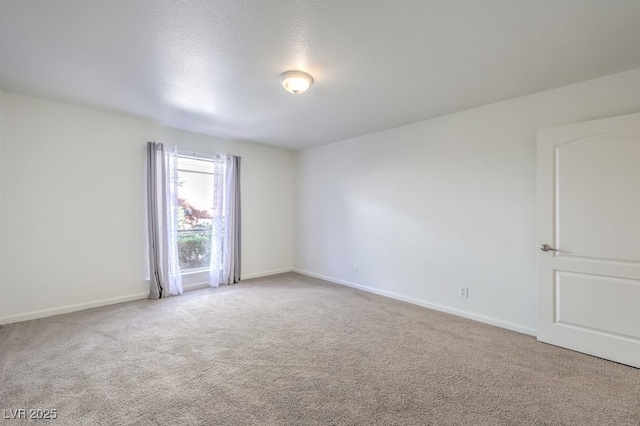 empty room featuring carpet flooring and a textured ceiling