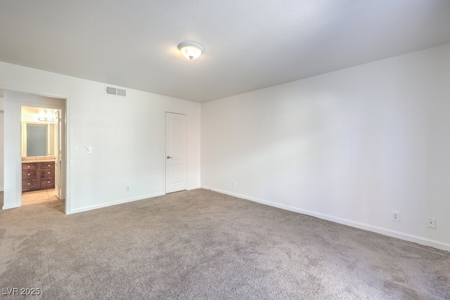 unfurnished room with light carpet