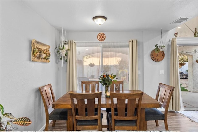 dining room with wood-type flooring