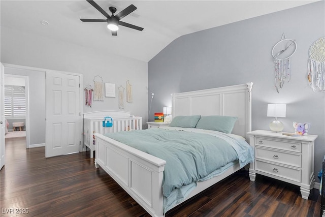 bedroom featuring dark hardwood / wood-style flooring, ceiling fan, and vaulted ceiling