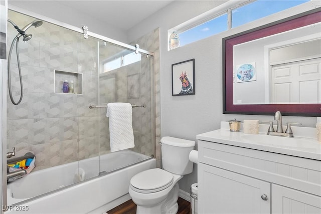 full bathroom with toilet, enclosed tub / shower combo, hardwood / wood-style floors, and vanity